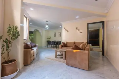 a living room with a couch and a table at Appartement Unique au Centre in Marrakech