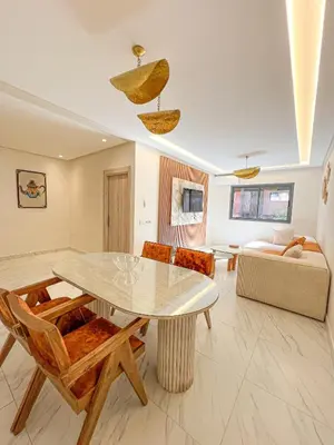 a living room with a table and a couch at Condo in marrakech with pool in Marrakech
