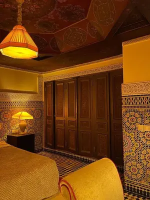 a bedroom with a bed and a lamp on a table at LUXURY apartment in Marrakech