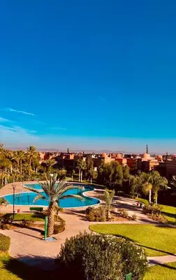 a view of a park with two swimming pools at Strasmarrakech in Marrakech