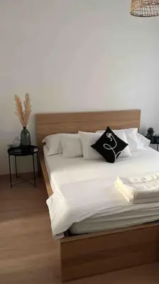 a bedroom with a bed with white sheets and pillows at Prestigia Golf entrée Agate (wifi) in Marrakech