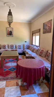 a living room with a couch and a table at Auberge de Jeunesse Marrakech-Asni in Marrakech
