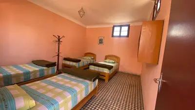 a room with three beds in a room at Auberge de Jeunesse Marrakech-Asni in Marrakech