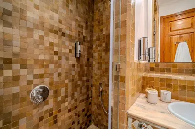 a bathroom with a shower and a sink at Family Stay aux jardins de la palmeraie in Marrakech