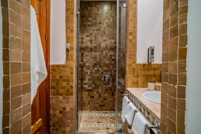 a bathroom with a shower and a sink at Family Stay aux jardins de la palmeraie in Marrakech