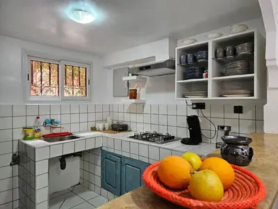 a kitchen with a bowl of fruit on a counter at Riad karya MEDINA in Marrakech