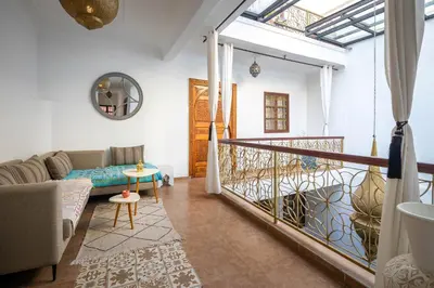 a living room with a couch and a table at Riad Dekkak, Maison complète en exclusivité in Marrakech