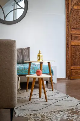 a coffee table in a living room with a couch at Riad Dekkak, Maison complète en exclusivité in Marrakech