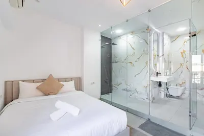 a bedroom with a glass shower and a bed at modern friendly appt in gueliz in Marrakech
