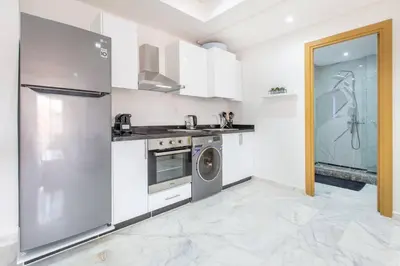 a kitchen with a washer and dryer in it at New! Guéliz , Modern , Terrasse in Marrakech