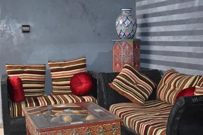 a living room with a couch and a vase at Riad Dar Alamane in Marrakech