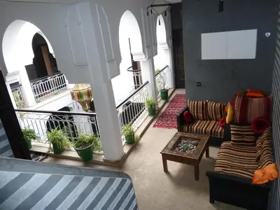 a living room with a couch and a coffee table at Riad Dar Alamane in Marrakech
