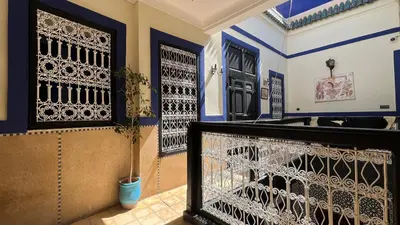 a house with blue and white walls and a gate at Riad Mamma MARRAKESH in Marrakech
