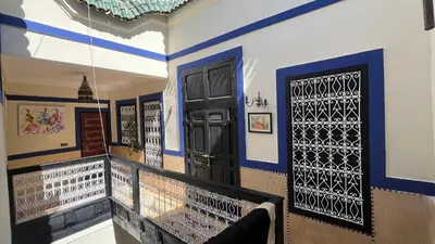 a room with a balcony with a black door at Riad Mamma MARRAKESH in Marrakech