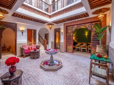 a lobby with a fountain in the middle of a room at Riad Kilimini & SPA in Marrakech