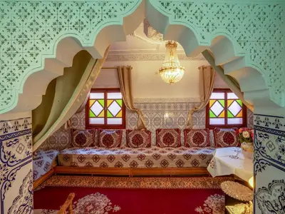 a living room with a couch and a chandelier at Pretty Apartment in the Medina in Marrakech