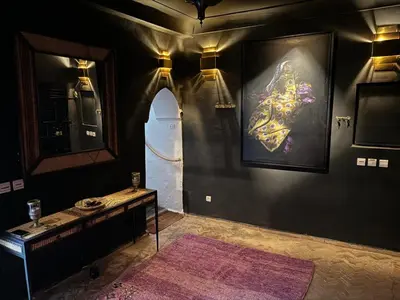 a bathroom with a large painting on the wall at Riad La Smala in Marrakech