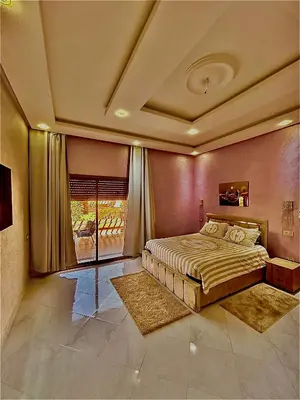 a bedroom with a large bed and a window at Villa djelloul s in Marrakech