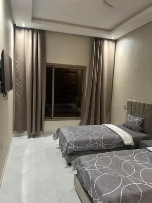 a hotel room with two beds and a window at Villa djelloul s in Marrakech