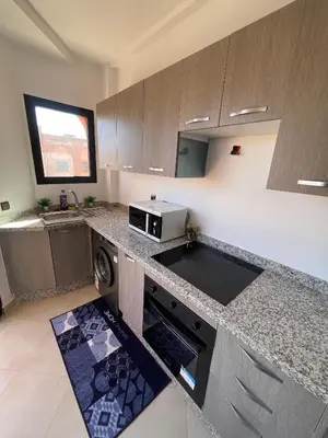 a kitchen with a stove and a microwave in it at Appartement Moderne Premium in Marrakech