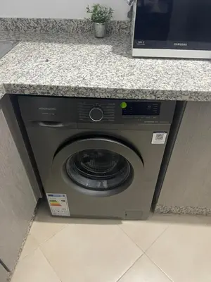 a washing machine under a counter in a kitchen at Appartement Moderne Premium in Marrakech