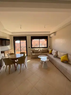 a living room with a couch and a table at Appartement Moderne Premium in Marrakech