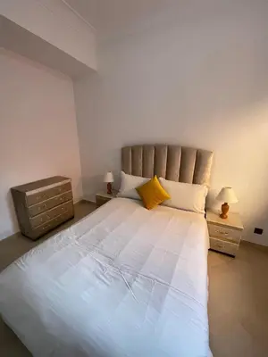 a bedroom with a large white bed with yellow pillows at Appartement Moderne Premium in Marrakech