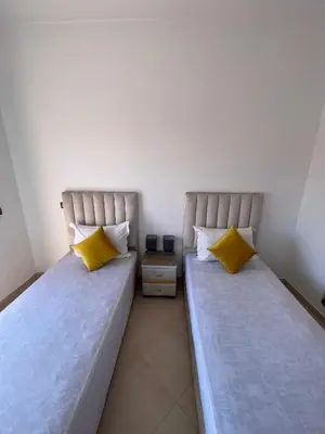 two beds sitting next to each other in a room at Appartement Moderne Premium in Marrakech