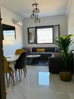 a living room with a couch and a table at Marrakech apartement in Marrakech