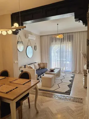 a living room with a couch and a table at Havre de paix bohème avec rooftop privée in Marrakech
