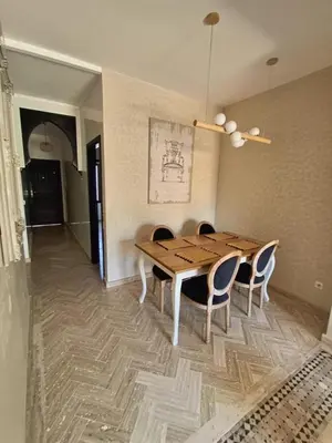 a dining room with a wooden table and chairs at Havre de paix bohème avec rooftop privée in Marrakech