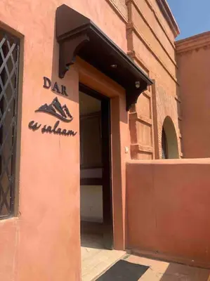 a door to a building with a sign for a shoe shop at Havre de paix bohème avec rooftop privée in Marrakech