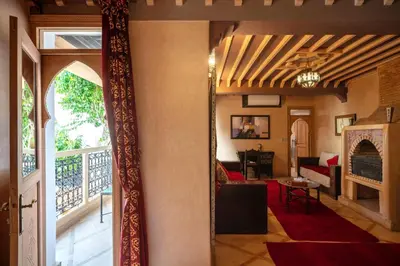an open door to a living room with a fireplace at Riad Fleur d'Orient in Marrakech