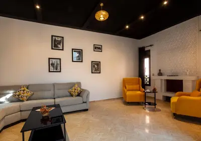 a living room with a couch and two chairs at Riad Tamazgha in Marrakech