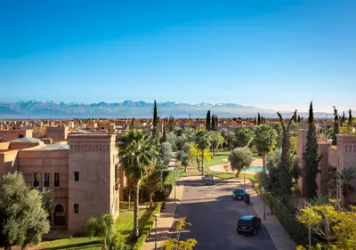 a view of a city with palm trees and a street at Riad Tamazgha in Marrakech