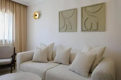 a living room with a couch with white pillows at Art Elegance – Downtown in Marrakech