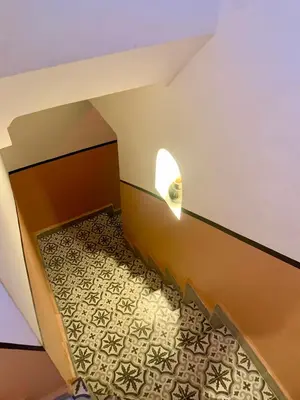 an attic hallway with a tile floor and a light at Riad Rosita 4 chambres in Marrakech