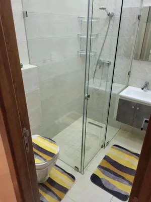 a bathroom with a shower and a toilet and a sink at Calista Appart hotel piscine in Marrakech