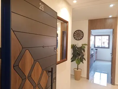a pivot door in a hallway with a kitchen at Calista Appart hotel piscine in Marrakech