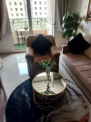a living room with a couch and a coffee table at Calista Appart hotel piscine in Marrakech