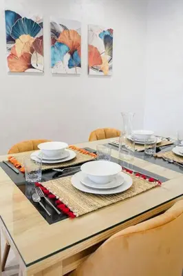 a dining room table with plates and dishes on it at La Dolce Casa – Private Pool in Marrakech