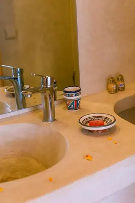 a bathroom sink with a plate of food on it at Riad Mama in Marrakech