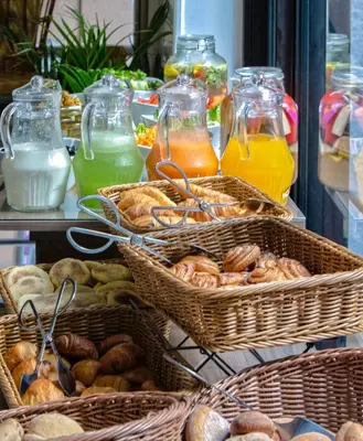 a buffet of baskets of bread and juice at Yaad City Hotel in Marrakech