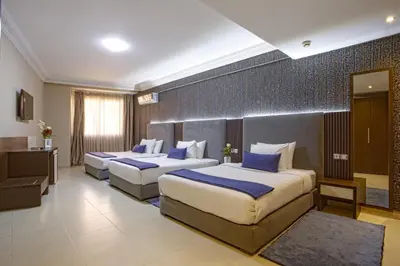 a hotel room with two beds in a room at Yaad City Hotel in Marrakech