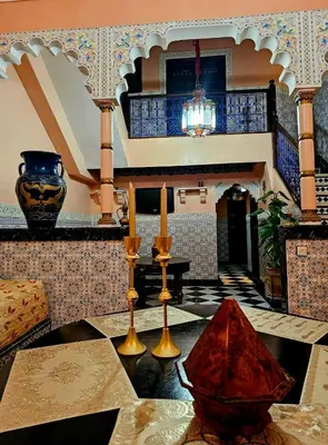a living room with a table with two candles on it at Riad yazuinaa in Marrakech