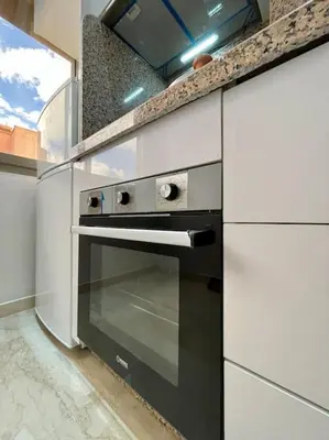 a kitchen with an oven in a white kitchen at Yumo: The Cozy One in Marrakech