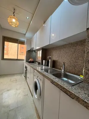 a kitchen with a sink and a washing machine at Yumo: The Cozy One in Marrakech