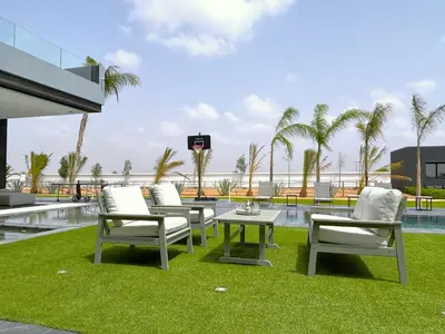 a patio with chairs and a table and a pool at Palais Kahli in Marrakech