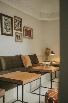 a living room with a couch and two tables at Riad Dar M in Marrakech