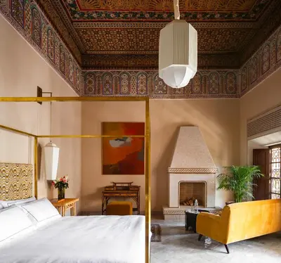 a bedroom with a bed and a fireplace at Riad Dar Al Dall - This Time Tomorrow in Marrakech in Marrakech